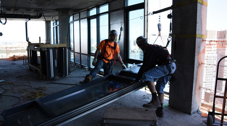 Sydney glaziers installing windows in commercial building